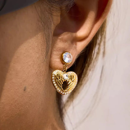 wings of love earrings, heart wings earrings, gold heart earrings, wing heart earrings for women, 18k gold plated heart earrings, zircon heart earrings, stainless steel gold earrings, minimalist gold earrings, delicate gold earrings, hypoallergenic gold earrings, romantic earrings gift, jewellery gift for her, valentines day earrings