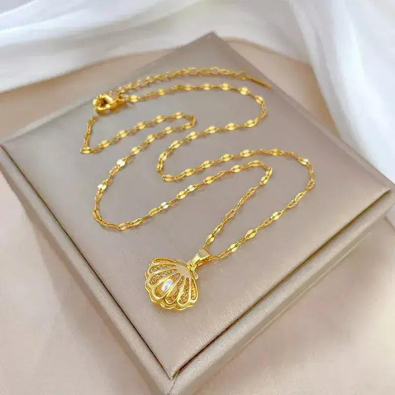 seashell pearl necklace, women’s seashell and pearl necklace, zirconia seashell necklace, elegant seashell necklace, modern pearl necklace, sophisticated women’s necklace, gift necklace for her, elegant beach style seashell necklace, women’s pearl jewellery, delicate seashell pendant necklace, luxury women’s necklace, pearl zirconia necklace gift, stainless steel women’s necklace, birthday gift necklace for women, necklace symbol of protection and love